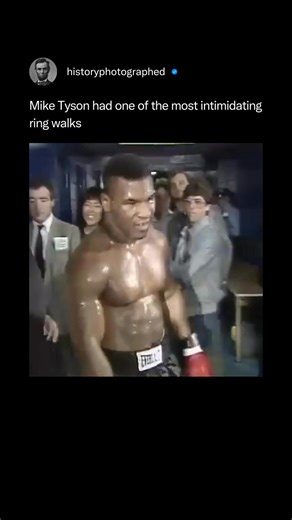Mike Tyson's ring walk was a masterpiece of psychological warfare, designed to be intensely intimidating through an atmosphere of silence, speed, and raw focus. Devoid of music in his prime, he relied solely on the building roar of the crowd and his imposing physicality to unnerve opponents before the match even began. Credit: @hbo | History In Pictures