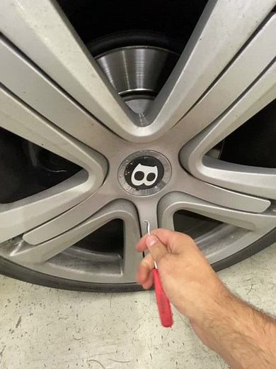 Removing Wheel Hub Cap Using a Screwdriver