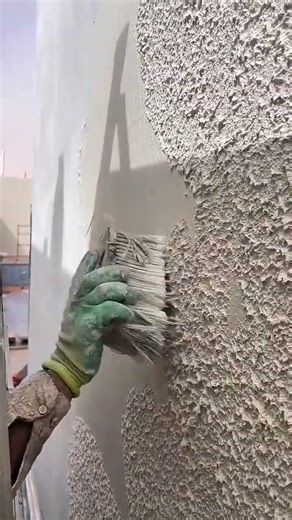 Applying textured coating on wall surface with wide brush