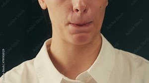 Woman bites her lips. Nervous tic. Obsessive-compulsive disorders. Patient of a psychiatric clinic biting lips, scratch face, biting nails, eye twitching. Close up, macro.