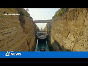 Cruise ship makes tight squeeze through canal