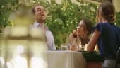 Four people, two couples happy talking and eating during a romantic...