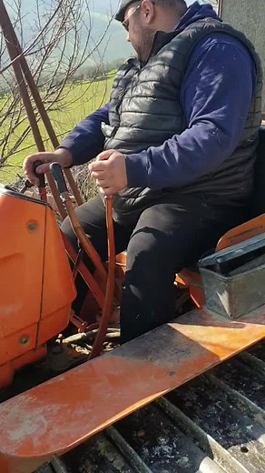 Operating an Orange Tractor for Agricultural Tasks