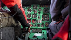 Cockpit of helicopter. Cabin inside, preparing for takeoff. Pilot's hand turns on right engine