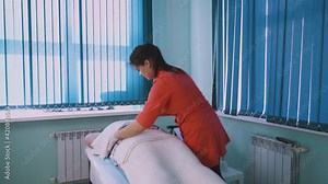 positive cosmetologist does electrical myostimulation procedure to young woman with overweight and stretch marks in cosmetology clinic