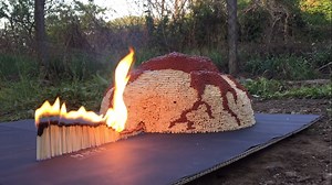 Watch a 52,000  Matchstick Volcano Burn Into A Towering Inferno