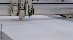 Digital cutting and creasing plotter - cnc flatbed cutter during work at factory, exhibition. Automated technology, industrial, robotic, electronic, production, manufacturing concept