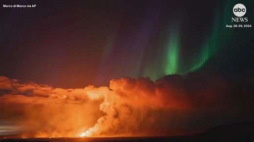 Northern lights shine as lava spews from erupting volcano in Iceland