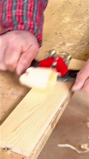 shaving the wood surface using a manual spokeshave tool to create smooth finish