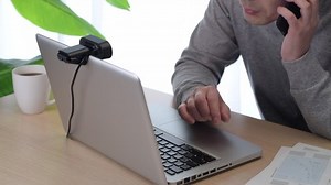 A man working remotely at home using a laptop.