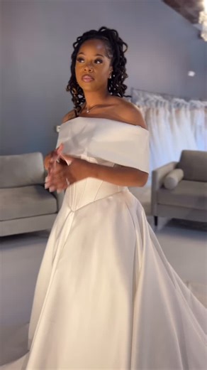 ✨ The Randy Fenoli 2026 Collection Continues ✨ We’re delighted to unveil another masterpiece from the Randy Fenoli 2026 Collection, now available exclusively at White Magnolia Bridal. 🤍 Meticulously crafted in silk Mikado, this gown embodies the perfect balance of modern grace and timeless sophistication. A sculpted corset bodice with exposed boning creates a soft basque waistline, while the modified cat-eye neckline elegantly frames the décolletage. The detachable shawl offers a touch of versa