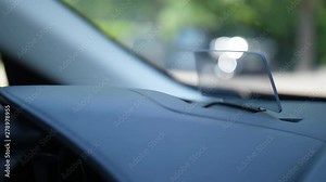 Close-up of transparent car projector for visualization in front of driver's eyes. Digital data from dashboard to monitor readings of speedometer and other devices