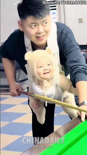 Baby billiards player ready to play