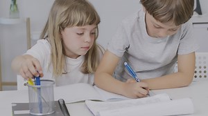 Download Brother helps his younger sister to make her homework for free