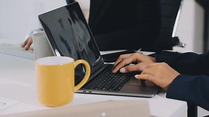 Download A person typing on a laptop computer for free