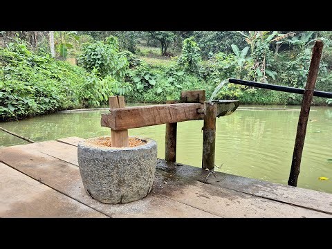 Stone mortar and pestle for grinding corn using water power.