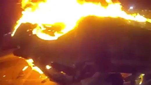 Horrifying moment car explodes in fireball as cops pull passenger out of wreck