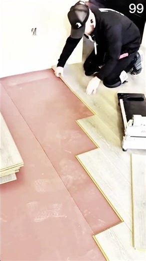 Wood plank set in staggered pattern, flooring installation progresses