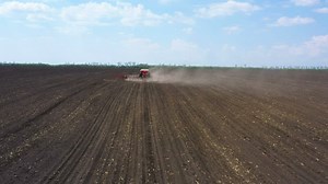 Red big tractor plowing the field - Free Stock Video