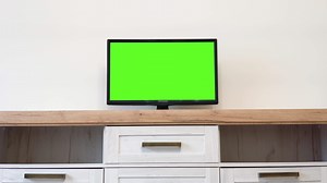 Chroma key screen for advertising. LcD smart TV screen with a blank green background in the living room