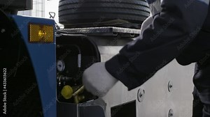 Close up of air venting pump for tires inflating. Scene. New professional equipment at the service center and a worker using it in overalls and protective gloves.