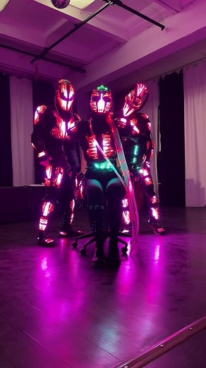Futuristic Dance Performance in Neon Costumes