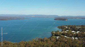 Lake Maqauarie Murrays beach jetty and beach in aerial flying over town as 4k.