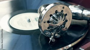 Tonearm needle of the old vintage gramophone slides along the track of the retro plate