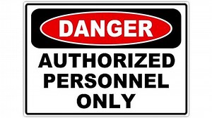 Footage of an authorized personnel only sign, the shot is coming into focus and goes again out of focus...