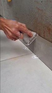 Installing baseboards on a house renovation project #porcelain #studioapartment #tilelayer #const...