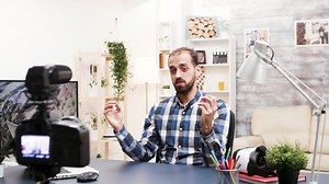 Famous influencer using modern technology to record his vlog. Vlogger talking with subscribers.