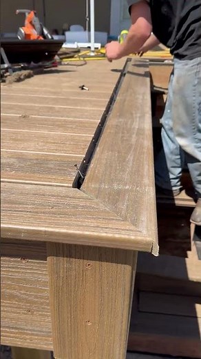Installing Trex picture frame after cutting the ends with a track saw.