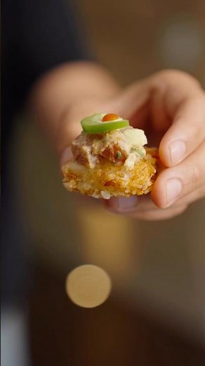 Crispy sushi rice with spicy tuna, avocado, jalapeño, chili crisp, and a heat #sushirice #cooking