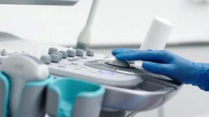The hands of an ultrasound diagnostician on the control panel of an ultrasound machine during the examination. The concept of modern technology and advanced methods in medical imaging