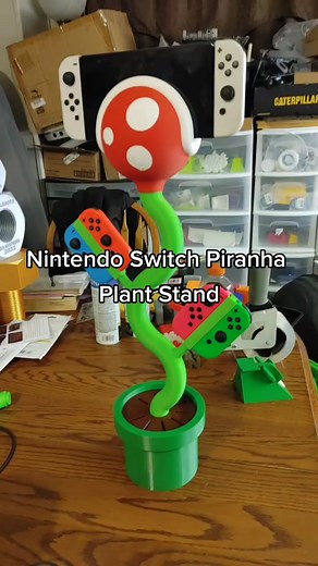 It's the Nintendo Switch Piranha Plant Stand! Charges your Switch via USB C cable through the stem, holds 4 extra joycons, 10 game cartridges! Connect a USB C hub with HDMI output to use on the TV! Digital files --> https://cults3d.com/en/3d-model/game/nintendo-switch-plant-stand-charging Search