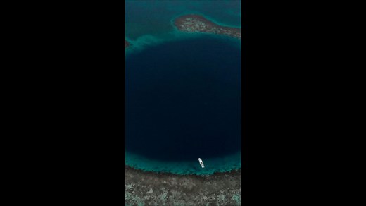 Soaring over Belize's Great Blue Hole: Aerial Wonders Revealed.