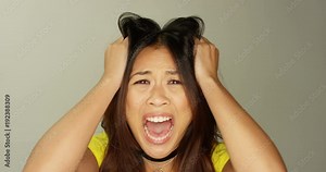 4K Close up woman staring into camera lens, shouting with mouth wide open. Slow motion.