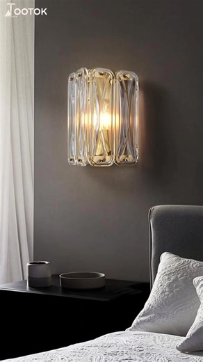 Stacked wavy crystal columns glow like a golden light tower on walls.#walllight
