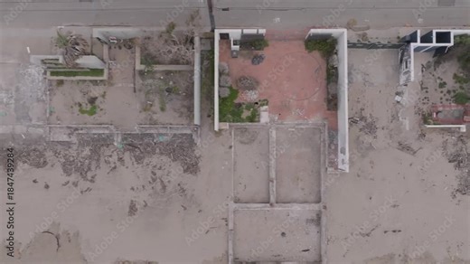 A dramatic aerial burn-down shot over Malibu looks straight down while moving from right to left, revealing rooftops, streets, and the Pacific coastline in a dynamic sweep.