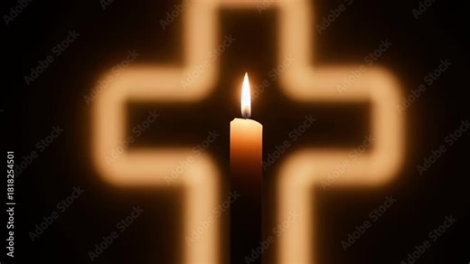 Candle flame flickering in front of glowing cross brings a sense of peace and reflection