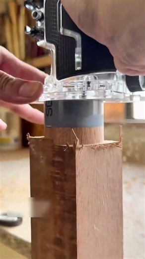 trimming and shaping the edges of a wooden block using a hand router with a guide bit for woodwork