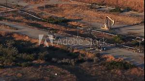 Aerial view of the oil rigs and wells in the Midway-Sunset shale oil fields, the largest in California. A pumpjack operates at an oil field. Oil pump rig energy industrial machine for petroleum. Stock Video