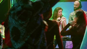 Confident woman doing karaoke on stage, singing songs with male DJ in front of people at nightclub. Happy girl having fun with live perfromance next to audio mixing station in club. Generative AI
