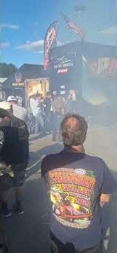 Top fuel nitro methane dragster start up and throttle bump clearing out a crowd