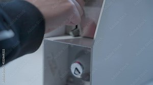 Person inserting coins in the washing machine