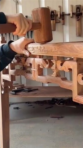 Handcrafted wooden furniture frame with intricate joints and detailed carvings in workshop