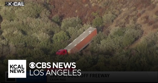 Traffic on I-15 impacted after big rig veers off freeway and rolls down hillside