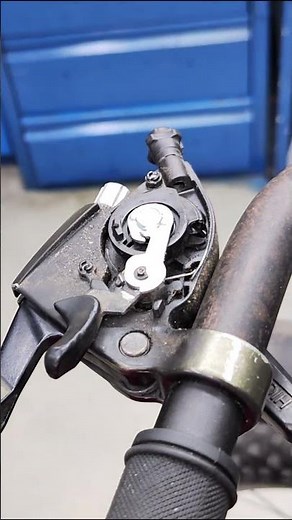 Removing the shift cable from the gear shifter of a bicycle