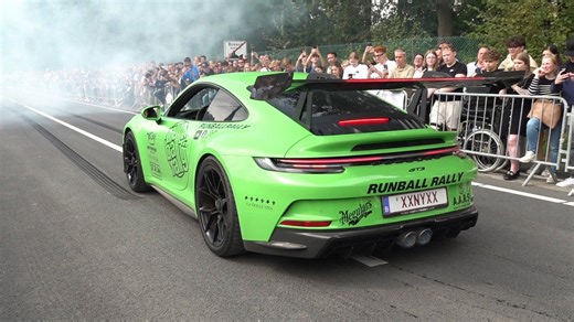 Porsche 911 GT3 accelerating in front of the crowd