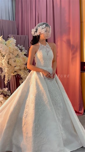 Yoss Bridal on Instagram: "This ball gown features intricate cornelli (corded) lace embroidery, creating a raised, sculptural texture that adds depth and dimension to the fabric. The hand-laid cording traces floral motifs across the bodice and skirt, a key bridal trend that emphasizes craftsmanship and tactile luxury. Paired with a halter neckline and voluminous silhouette, the gown balances modern structure with timeless romance—perfect for brides seeking refined detail without excessive embell